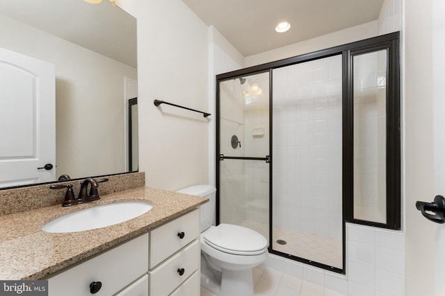 bathroom featuring recessed lighting, toilet, a stall shower, and vanity