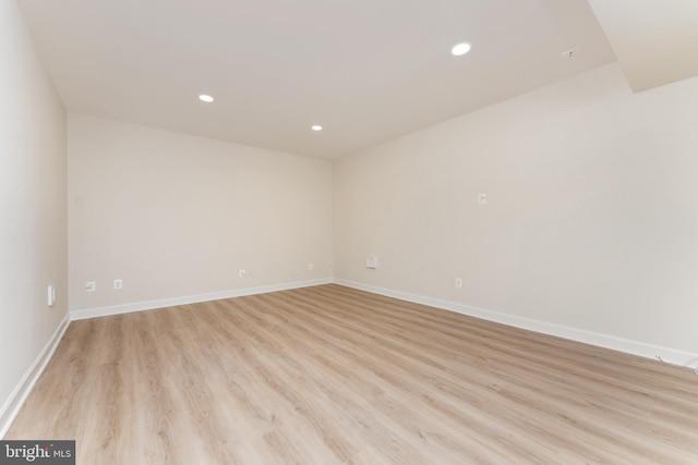 unfurnished room featuring recessed lighting, baseboards, and light wood finished floors