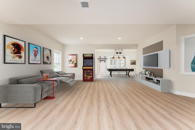 living room with recessed lighting, baseboards, visible vents, and light wood finished floors