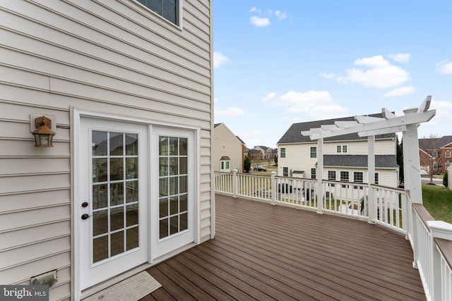 wooden terrace with a residential view and a pergola