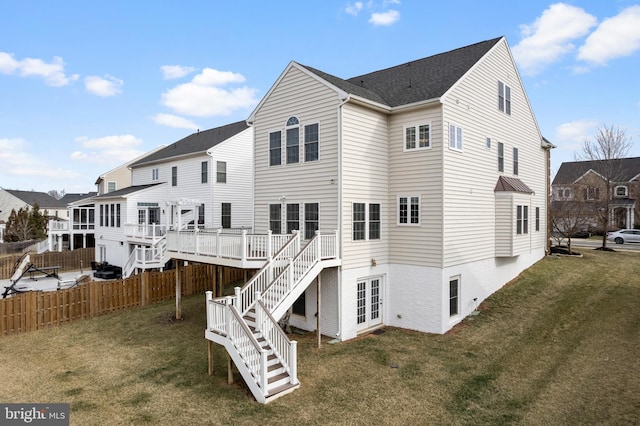 rear view of house with stairway, fence, a wooden deck, a yard, and a shingled roof