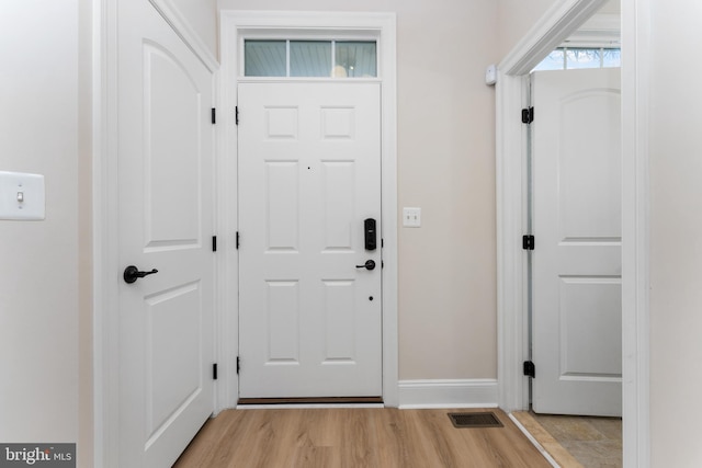 entrance foyer featuring visible vents, baseboards, and light wood-style floors