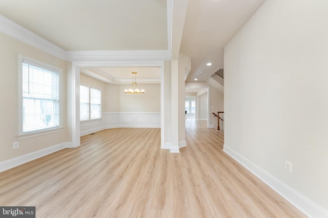 unfurnished room with a wainscoted wall, an inviting chandelier, light wood-style flooring, recessed lighting, and crown molding