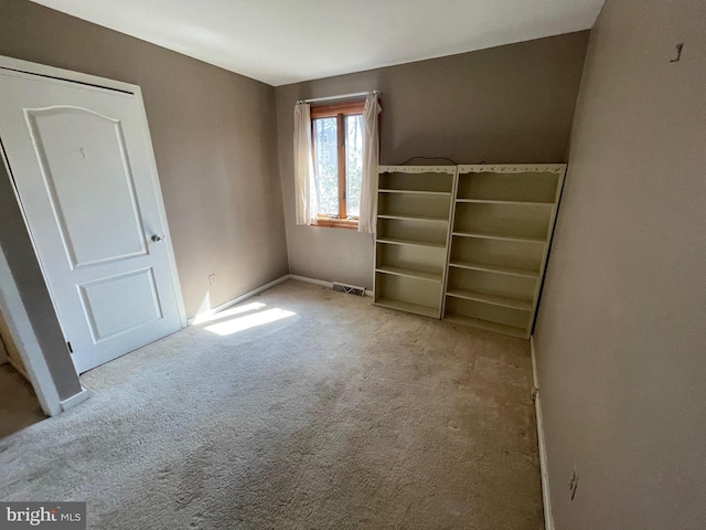 unfurnished bedroom with visible vents, baseboards, and carpet floors