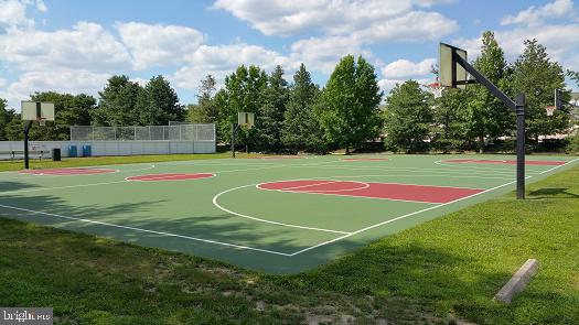 view of sport court with community basketball court and fence