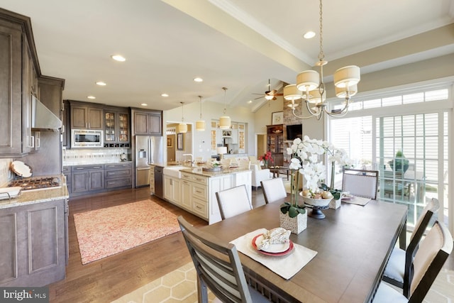 30748 Fowlers Path, Millsboro, DE 19966 - dining room with lofted ceiling, ceiling fan with notable chandelier, wood finished floors, and recessed lighting