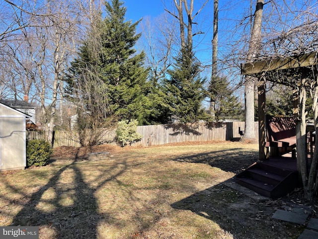 view of yard featuring fence and a wooden deck