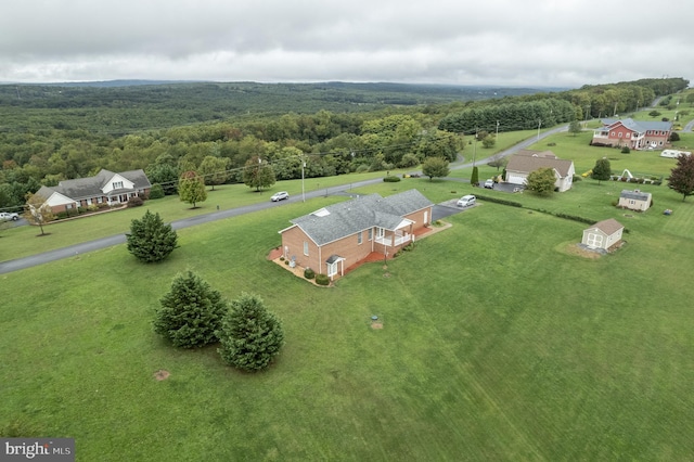 drone / aerial view with a wooded view