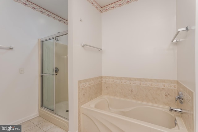 full bath featuring a stall shower, a bath, and tile patterned floors