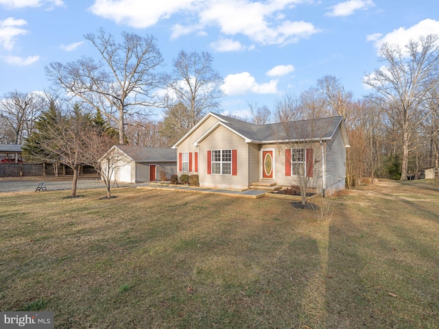 single story home featuring an attached garage, an outdoor structure, and a front lawn