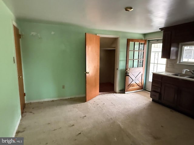 kitchen featuring a sink and baseboards