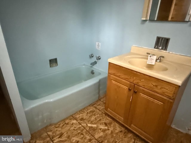 full bath featuring a tub to relax in, tile patterned flooring, and vanity