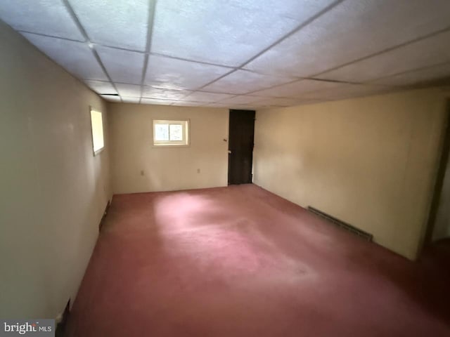 below grade area with carpet floors and a drop ceiling