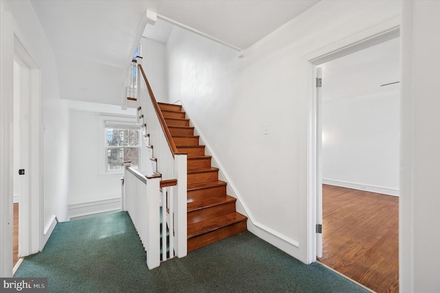 staircase with carpet floors and baseboards