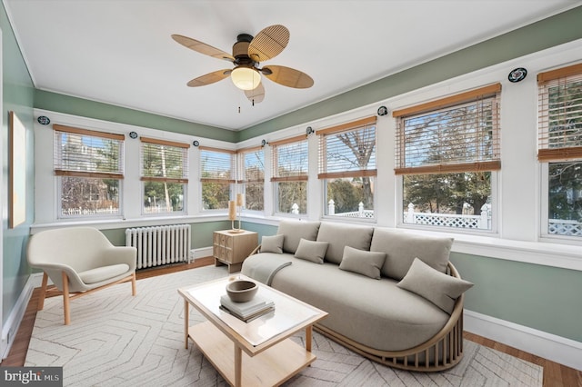 sunroom / solarium with radiator heating unit and ceiling fan