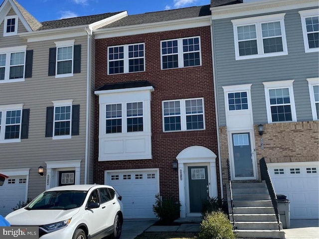 multi unit property featuring brick siding and an attached garage