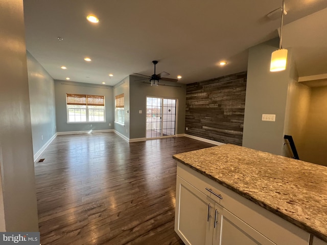 kitchen featuring dark wood-type flooring, recessed lighting, open floor plan, and white cabinets