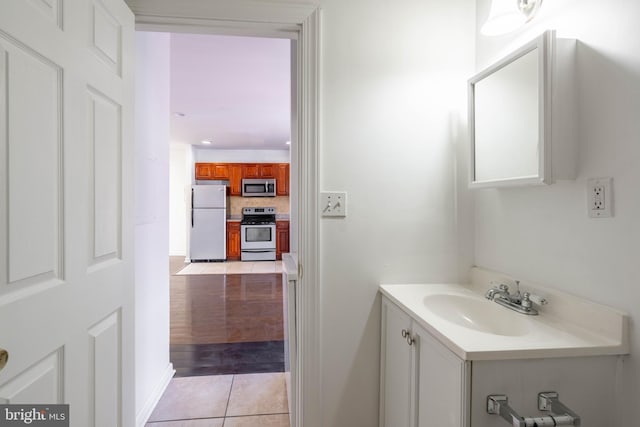 bathroom featuring tasteful backsplash, vanity, and tile patterned floors