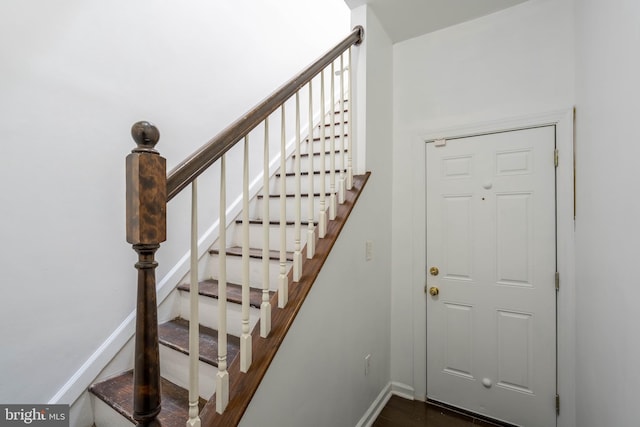 stairs featuring baseboards and wood finished floors