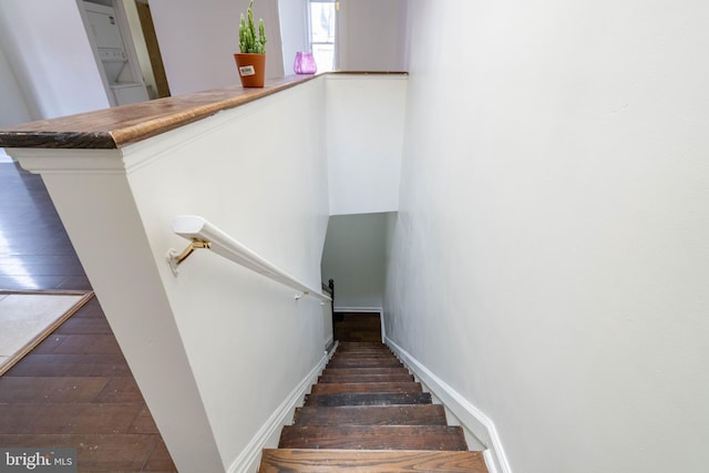 stairs featuring wood-type flooring and baseboards