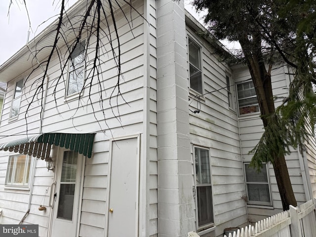 view of side of home with fence