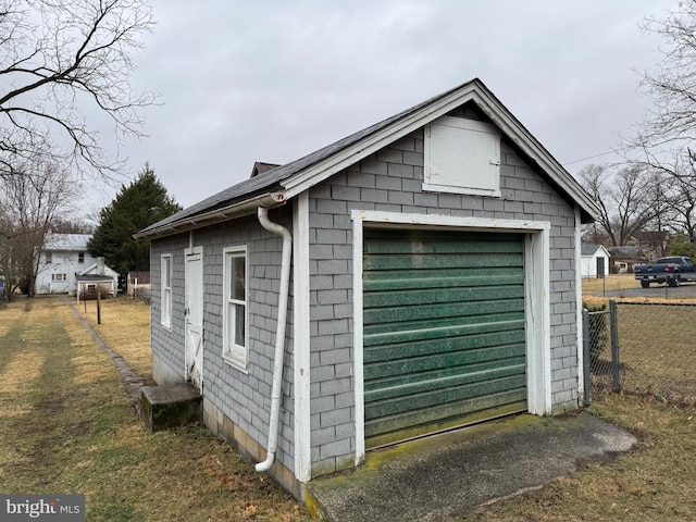 view of outbuilding with fence and an outdoor structure