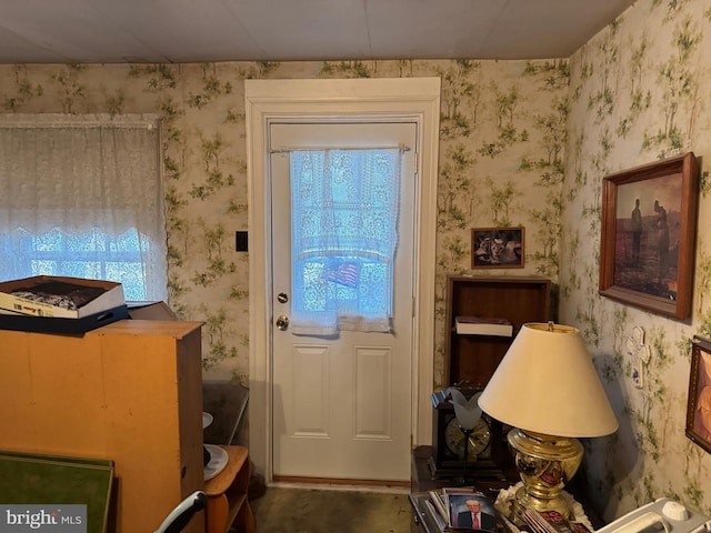 doorway featuring wallpapered walls