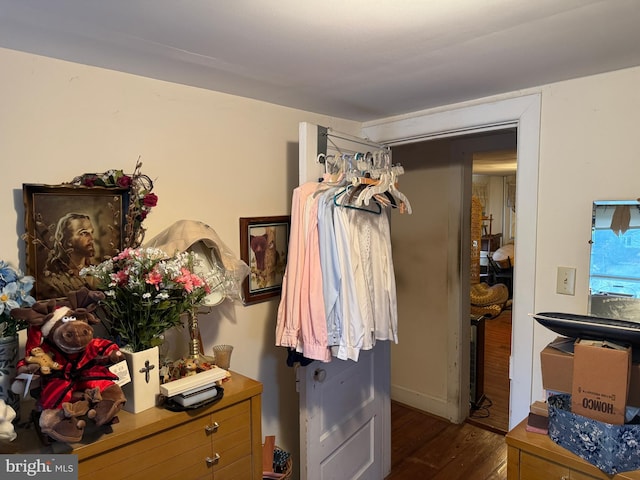 bedroom with dark wood-type flooring