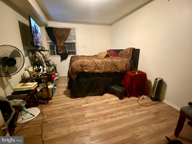 bedroom with wood finished floors