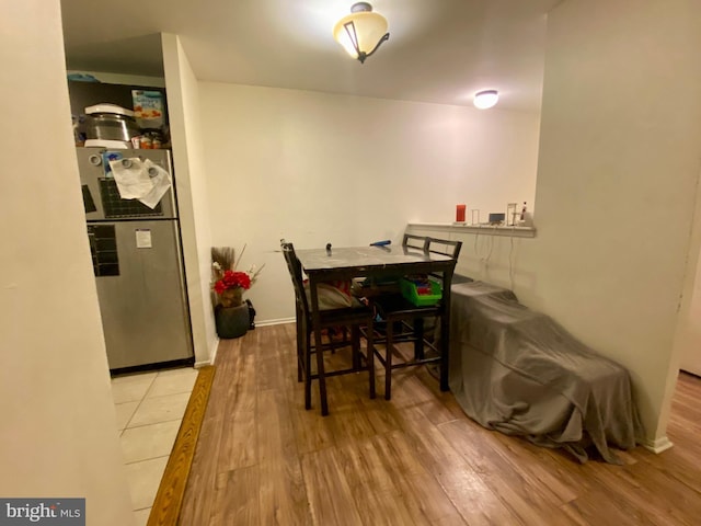 dining area featuring baseboards and wood finished floors