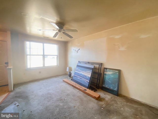 interior space with ceiling fan