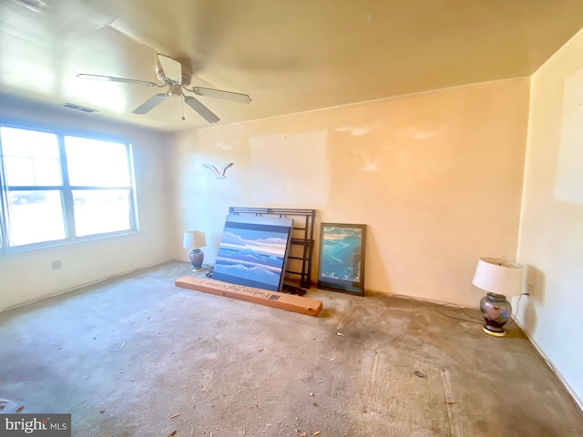 unfurnished living room with carpet, a ceiling fan, and visible vents