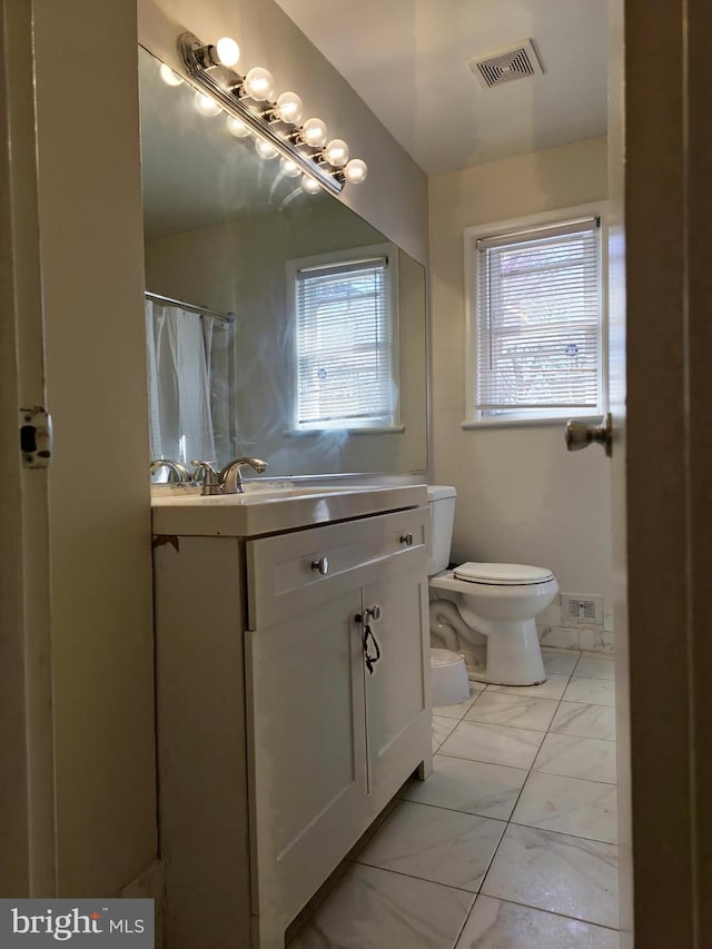 1205 Stratwood Ave, Oxon Hill, MD 20745 - bathroom featuring toilet, visible vents, marble finish floor, and plenty of natural light