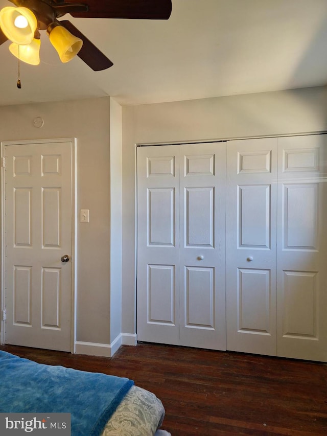 1205 Stratwood Ave, Oxon Hill, MD 20745 - unfurnished bedroom with dark wood finished floors, baseboards, a closet, and a ceiling fan