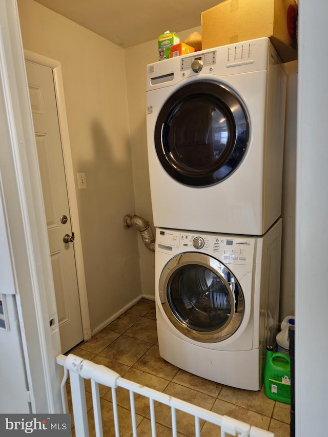 1205 Stratwood Ave, Oxon Hill, MD 20745 - washroom with baseboards, stacked washer and clothes dryer, laundry area, and tile patterned flooring