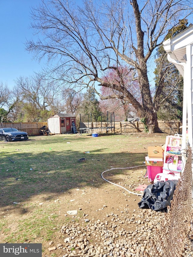 1205 Stratwood Ave, Oxon Hill, MD 20745 - view of yard featuring a storage shed, a trampoline, an outdoor structure, and fence