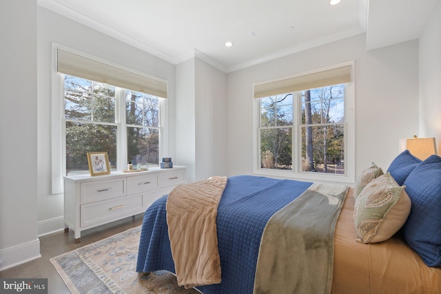 bedroom featuring ornamental molding, dark wood-style flooring, multiple windows, and baseboards