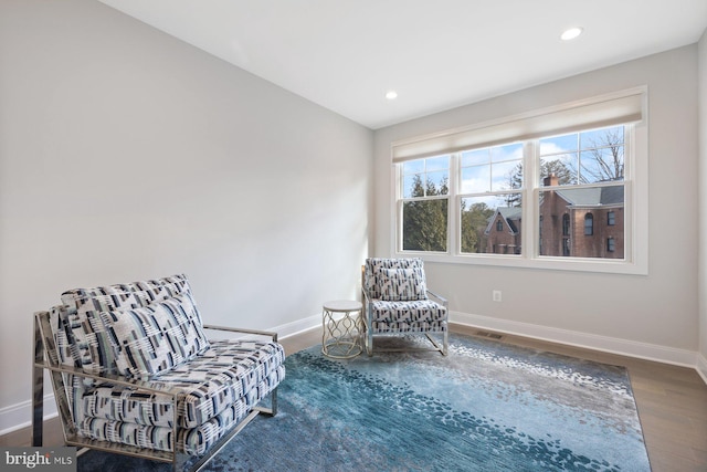 sitting room featuring baseboards, wood finished floors, and recessed lighting