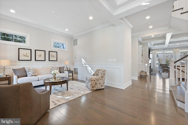 living area featuring visible vents, beamed ceiling, a wealth of natural light, and wood finished floors