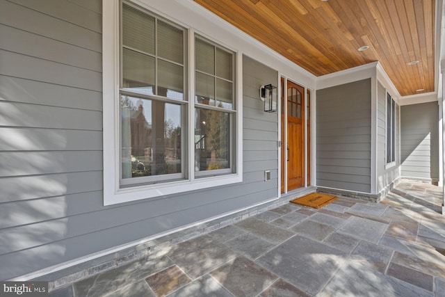 view of exterior entry with covered porch