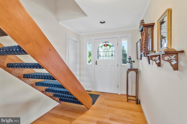 entrance foyer featuring wood finished floors and crown molding