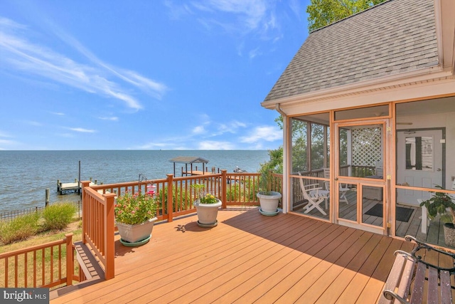 wooden terrace with a sunroom and a water view