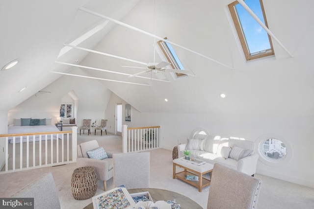 carpeted living area featuring plenty of natural light, high vaulted ceiling, and a skylight