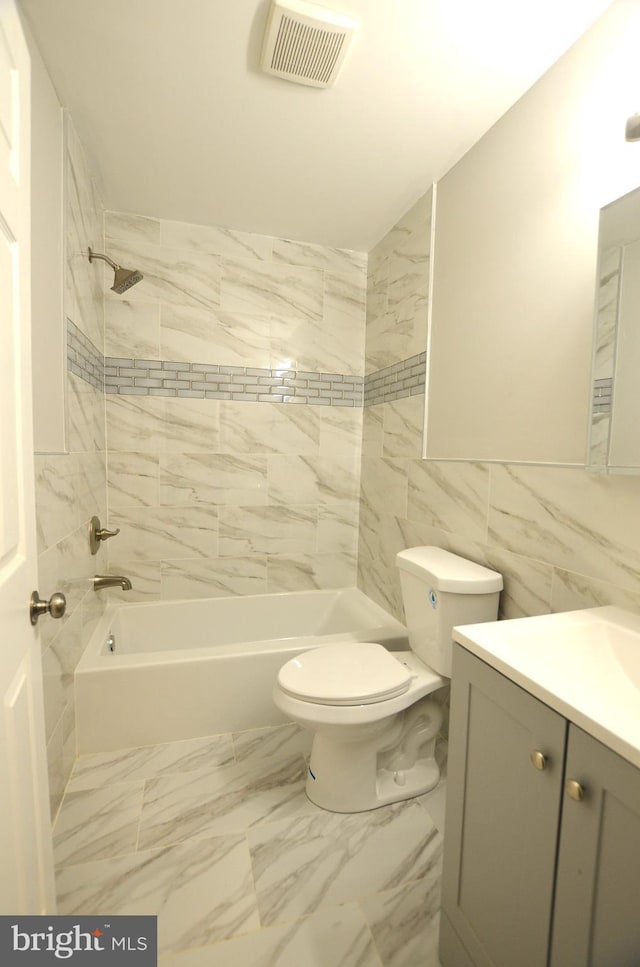 bathroom featuring vanity, visible vents, bathtub / shower combination, toilet, and marble finish floor