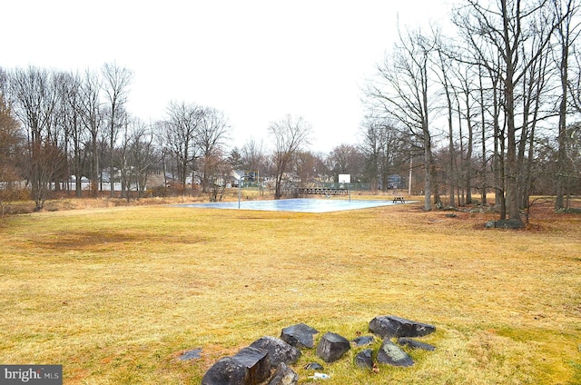 view of yard with community basketball court