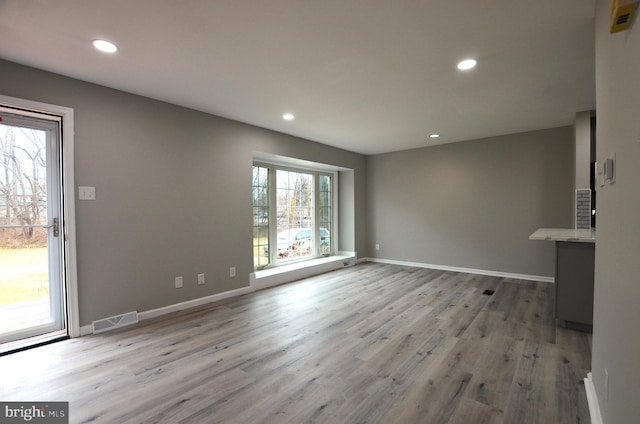 interior space featuring recessed lighting, visible vents, baseboards, and wood finished floors