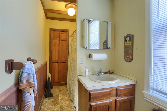 bathroom featuring stone finish floor and vanity