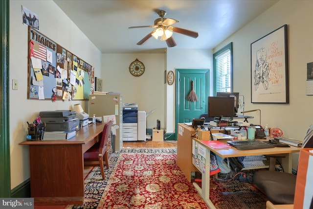 office area featuring wood finished floors, a ceiling fan, and baseboards