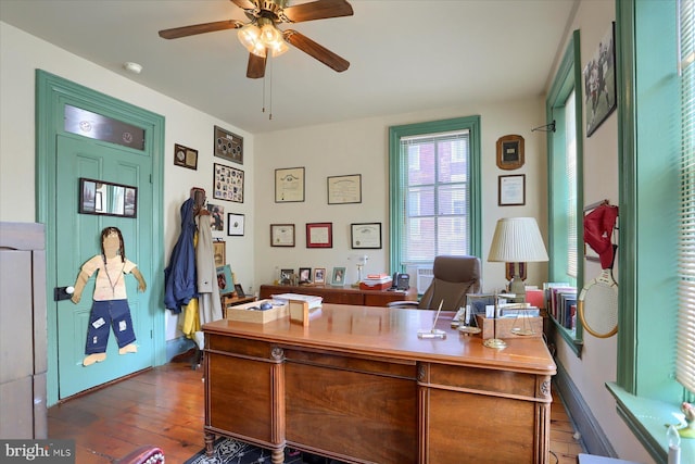 office with ceiling fan, baseboards, and dark wood-style flooring