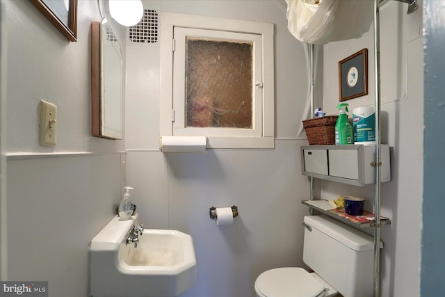 half bath with a sink and toilet